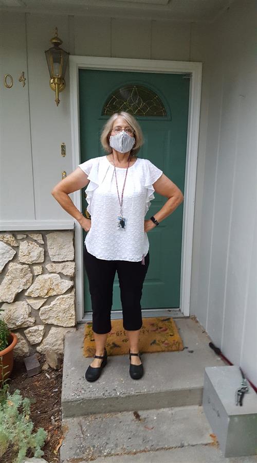 Image of Mrs. Daniels in superhero stance with hands on hips, ready for the first day of school.